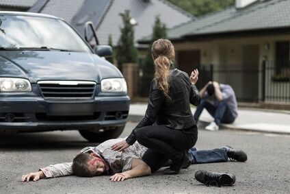 Victim of car accident Injured person laying on roadand women asking for help